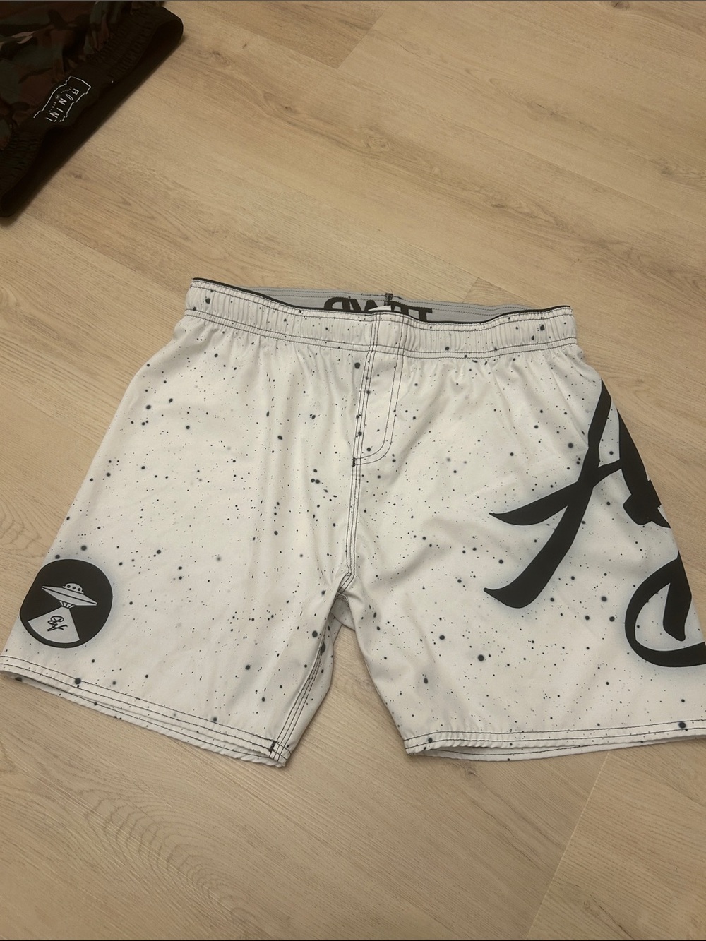 White Speckled Men's Swim Shorts with Black Graphic